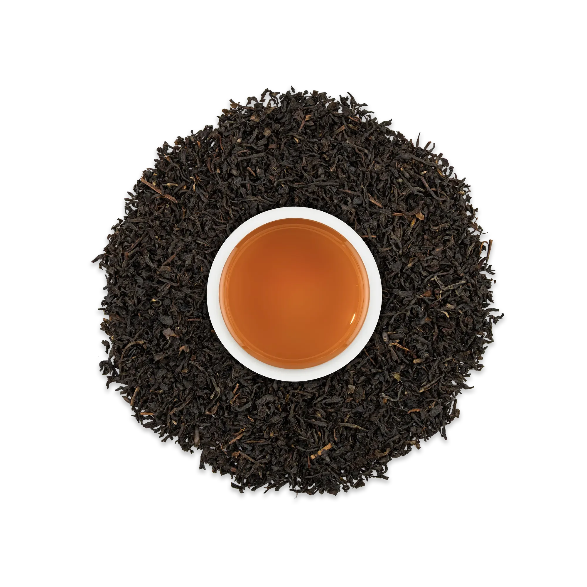 Weiße Tasse mit bernsteinfarbenem Schwarztee, umgeben von losem Schwarztee auf schwarzem Hintergrund.